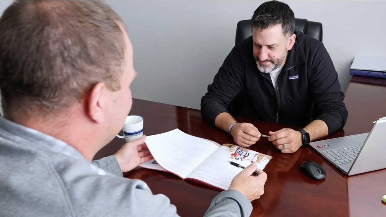 Agent Tony Roach talking with his client about insurance