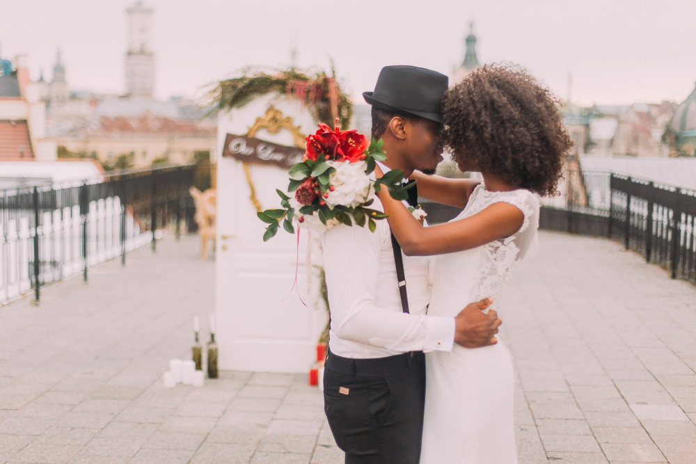 happy married couple standing on a pier