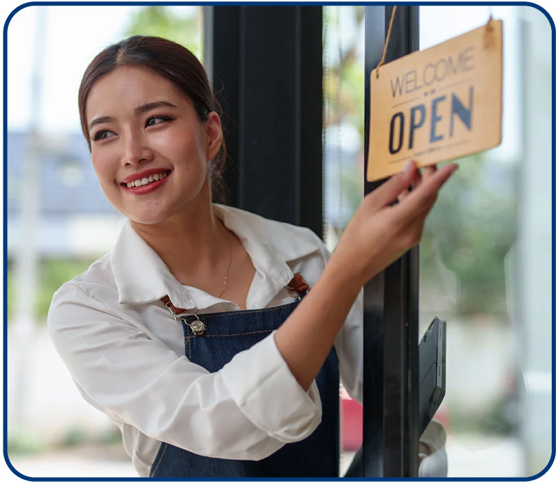 smiling young small business owner looking at tablet