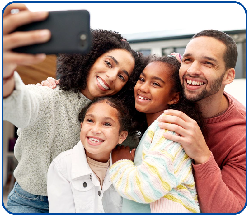 young family taking a picture infront of the house
