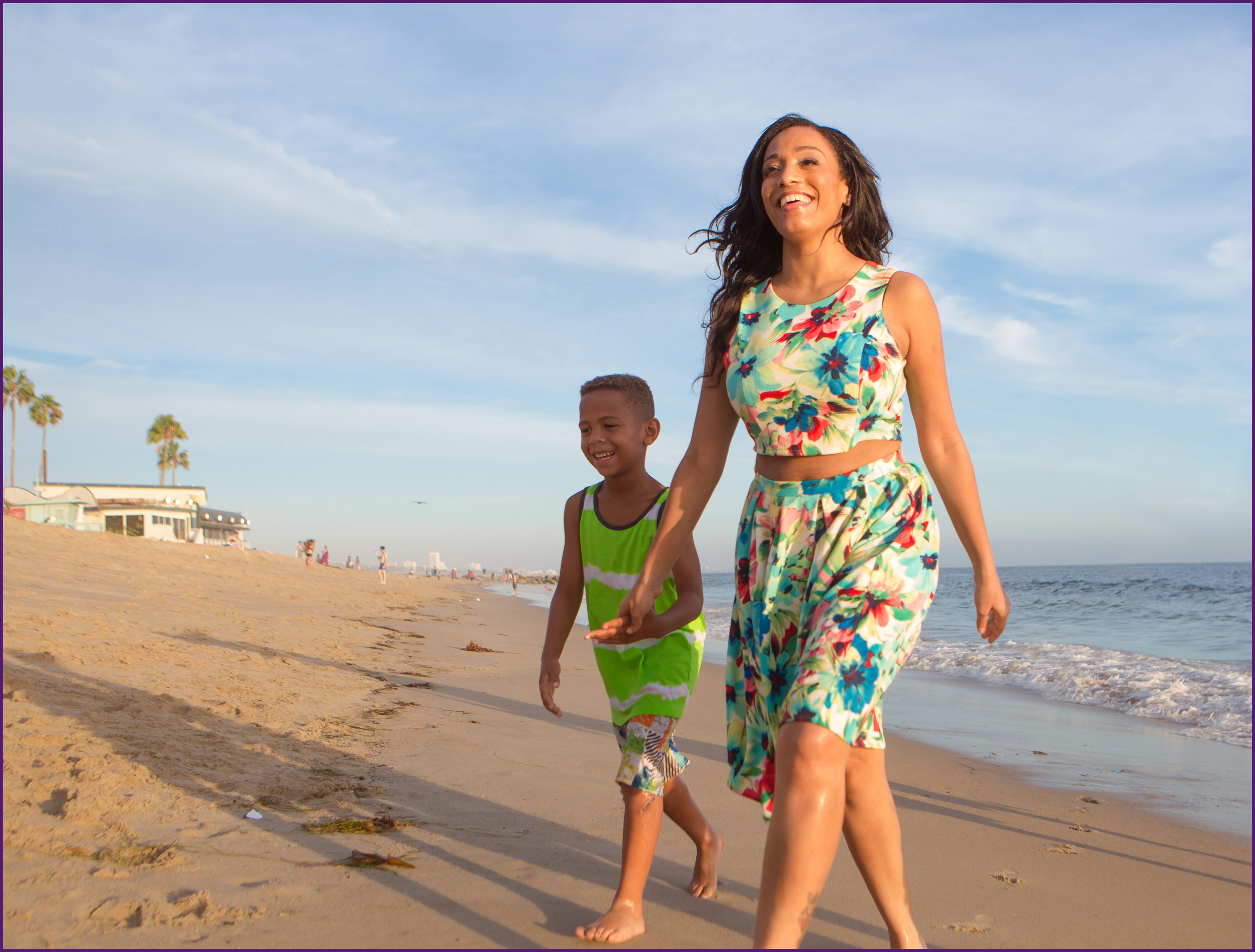 image of a mother walking with her son on the beach