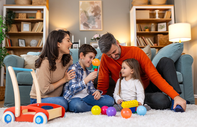 young family in their living room playing together