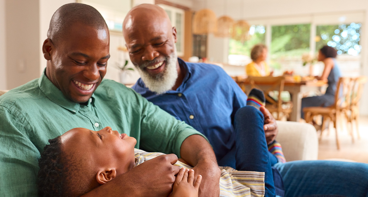 image of a father, son and grandfather playing on the couch