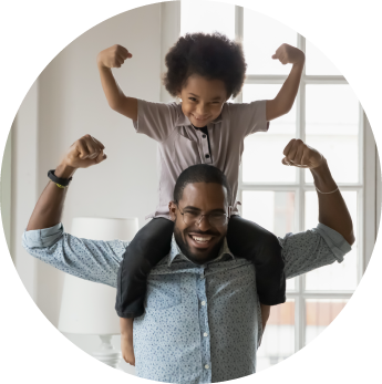 circular framed photo of a dad with his child on his shoulders and both of them flexing their arms