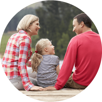 Image of a mother and father sitting with their daughter