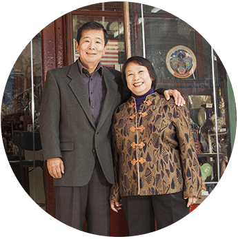 Couple standing in front of their family owned store