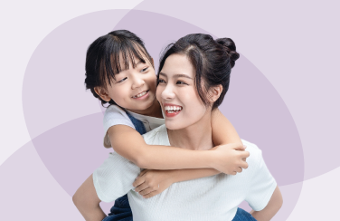 A mother giving her daughter a piggy back ride