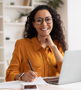 Business woman sitting at her desk in front of her computer